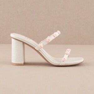 Slip on, rosette covered heels. Heel height: 3”. Size 7.5